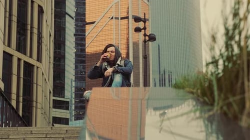 Young Adult Drinking Coffee in a Modern City