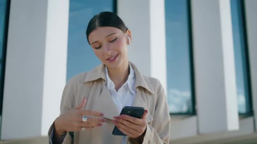 Cheerful Beautiful Woman Chatting On Video Call Using Wireless Headphones At Street Close Up. Hap...