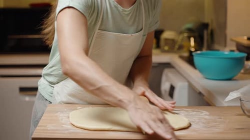 Rolling Dough on Kitchen Table for Baking