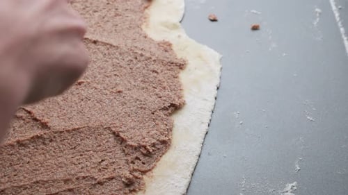 Close up on cinnamon bun dough with paste on