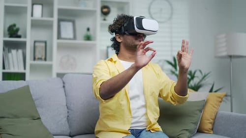 Man Using Virtual Reality Headset in Living Room