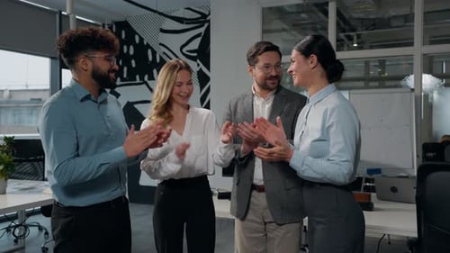 Business Team Applauds and High Fives in Office