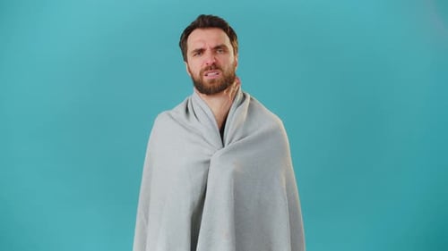 Man with Sore Throat Wrapped in Blanket