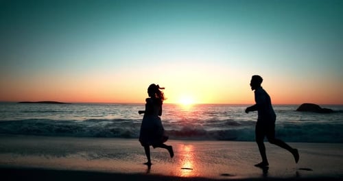 Couple, silhouette and waves at beach with playing for vacation, holiday