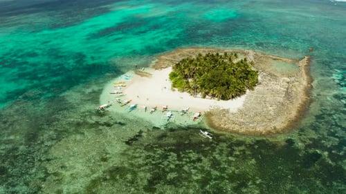 Tropical Guyam Island with a Sandy Beach and Tourists