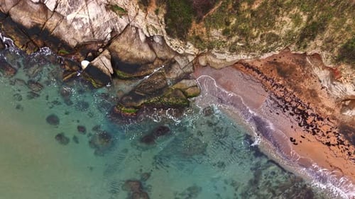 Beautiful coastal view showing cliffs, rocks, and clear water at shoreline