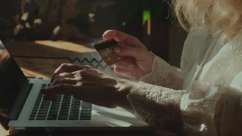 Woman Shopping Online Using Credit Card With Laptop