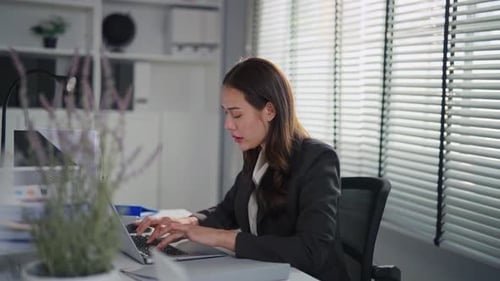 Frustrated Asian young businesswoman overwork late in office workplace