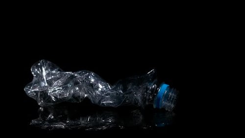 Crushed Plastic Bottle on Black, Dolly In