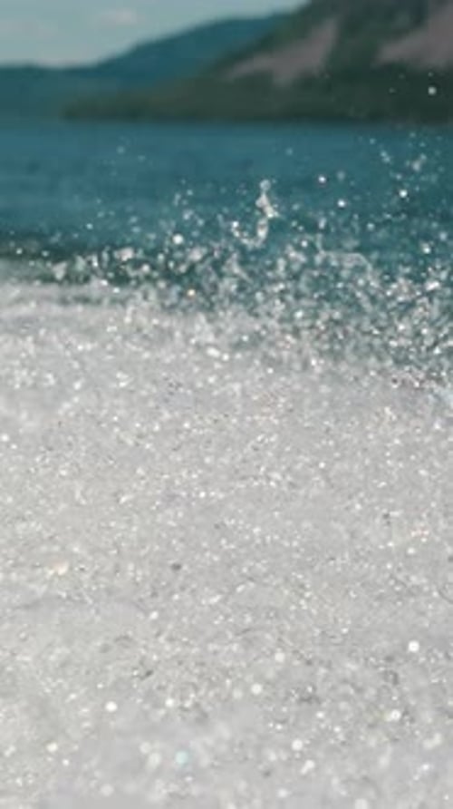 Sparkling Splashes on Surface of Lake After Boat Moving Ahead