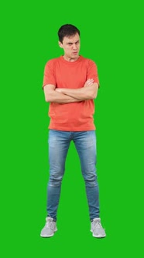 Angry Man with Crossed Arms Green Background