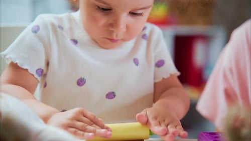 Cute Child Playing with Rolling Pin and Modeling Clay