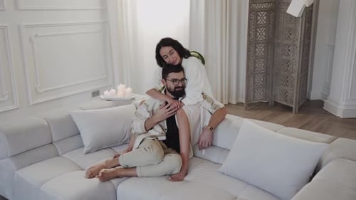 Romantic Couple Embracing on Modern Couch