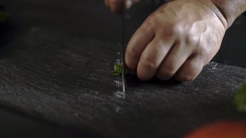 Cutting Green Onions on Black Cutting Board, Close Up View