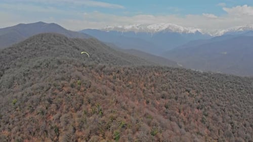Experience the freedom of paragliding amidst breathtaking mountain vistas.