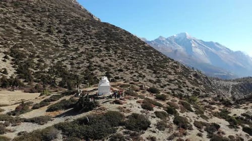 Hikers Next To Small Temples On Annapurna Circuit Viewing Majestic Mountain Range Of Annapurna In Ne
