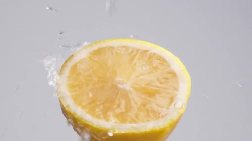 Refreshing Lemon Half Getting Washed with Water