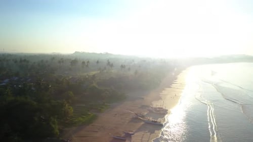 Rotating aerial shot of Weligama Beach, Sri Lanka at sunrise.