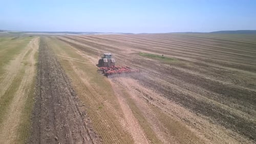 Tractor working on the field doing tillage with cultivator