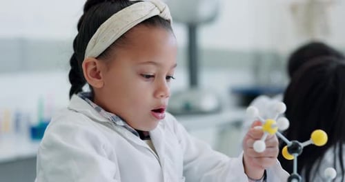 Enthusiastic Child Studying Molecule Model in Science Class