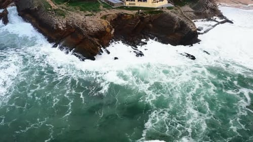 Aerial View of Rocky Cliff Coastline with Ocean Waves
