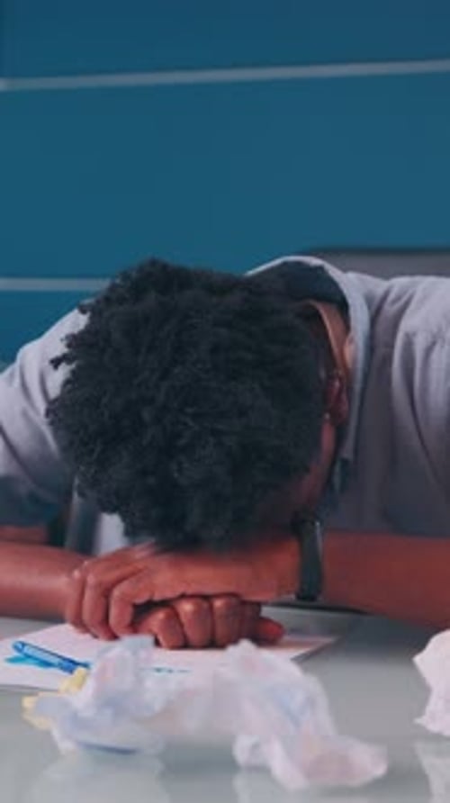 Overwhelmed Student Struggles with Stress in a Cluttered Study Space