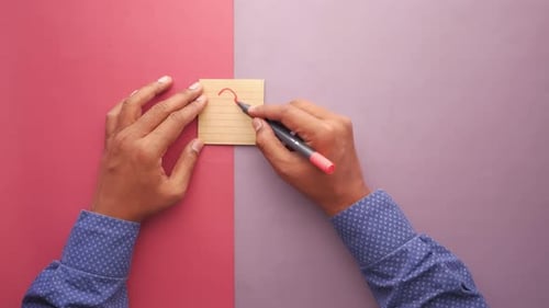 High Angle View of Writing Question Mark on Sticky Note