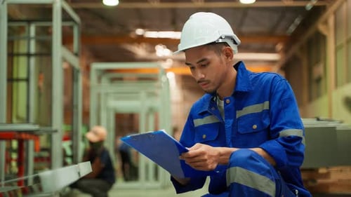 Asian attractive man industrial worker working in manufacturing plant.