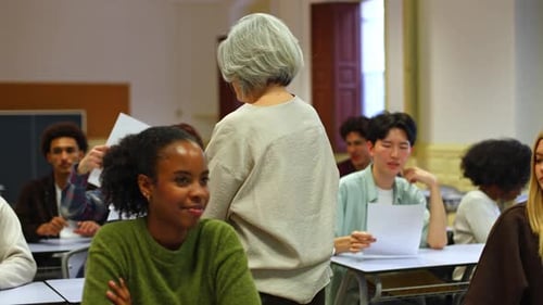 Senior Professor Interacting with Diverse University Students in Classroom