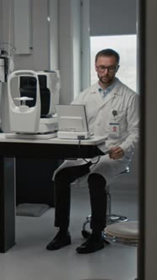Optometrist Performing Eye Exam Vertical