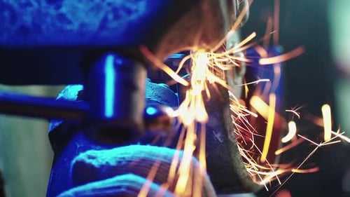 Professional Worker Works in Production with Metal