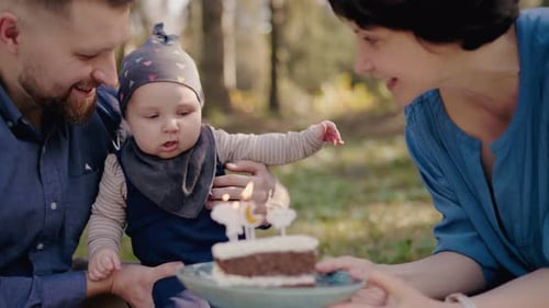 Happy Family Celebrating Baby's First Birthday Outdoors in the Park