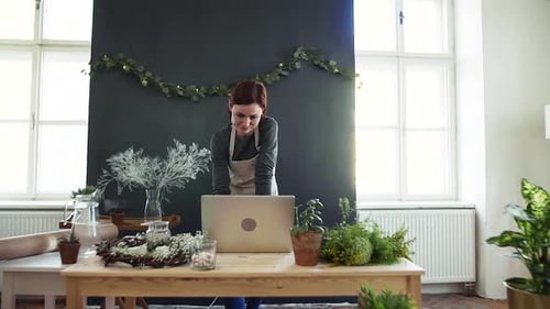 Young Creative Woman in a Flower Shop, Using Laptop. a Startup Of