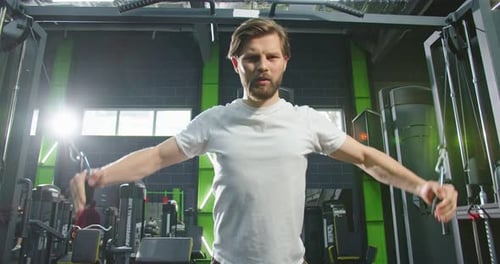 Bearded Strong Man Training His Arms with Straps Trx Fitness in the Gym During Quarantine Time for