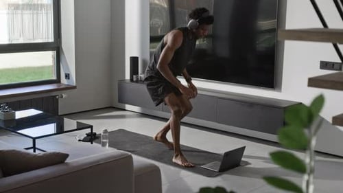 Man Doing Lunges and Yoga At Home