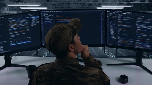Back View Of Asian Military Thinking About Something While Write Code In Data Center
