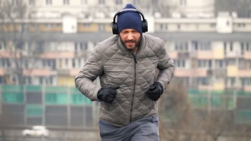 Male Jogger in Headphones Running in City Park, Super 240