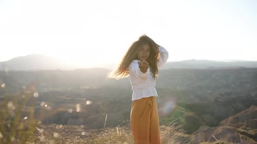 Woman Feeling Free and Happy at Sunset in the Desert