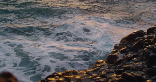 Sea Splashes Breaking on Stones Closeup
