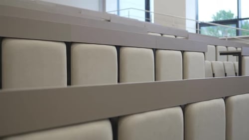 Rows of Soft Chairs Arranged Neatly in Spacious Lecture Hall