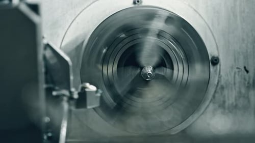 Metal lathe machine in action at precision engineering workshop