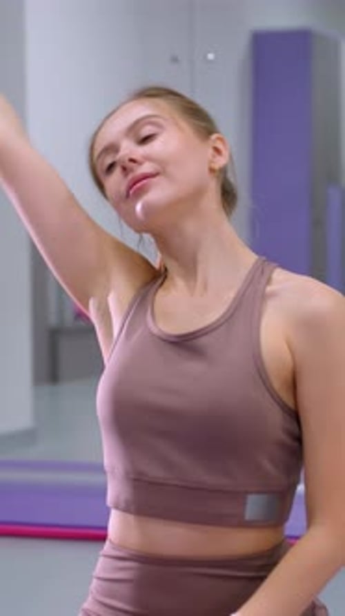 Woman Stretching Neck Seated in Gym