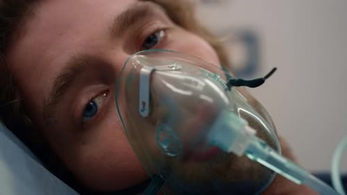 Closeup Ill Man in Oxygen Mask Lying on Stretchers in Emergency Car