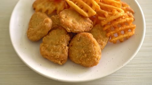 fried chicken nuggets with fried potatoes