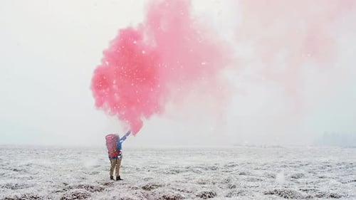 Person With Flare in Snowy Winter Field