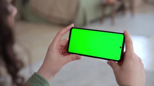 Close Up View of Woman Hands Using Horizontal Smartphone with Key Green Screen Chroma Key Mock Up