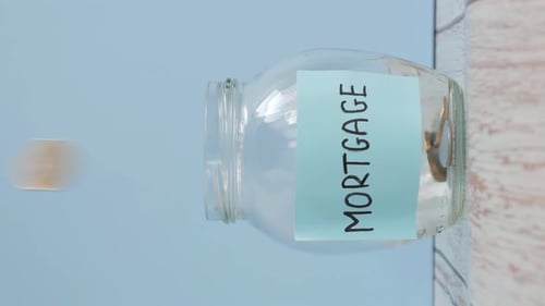 Coins Fall into Mortgage Savings Jar
