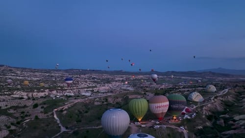 Hot Air Balloons Fly Over the Mountainous Landscape of Cappadocia Turkey