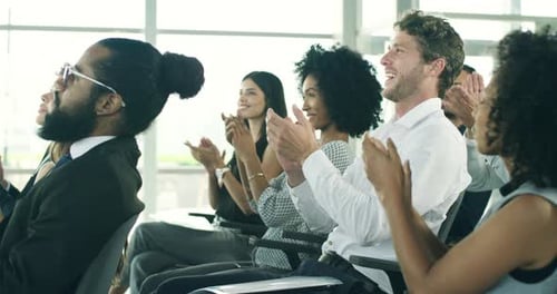 Business Professionals Applaud at a Corporate Conference