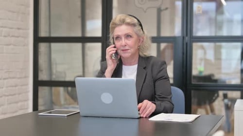 Senior Woman Working in Office Using Phone